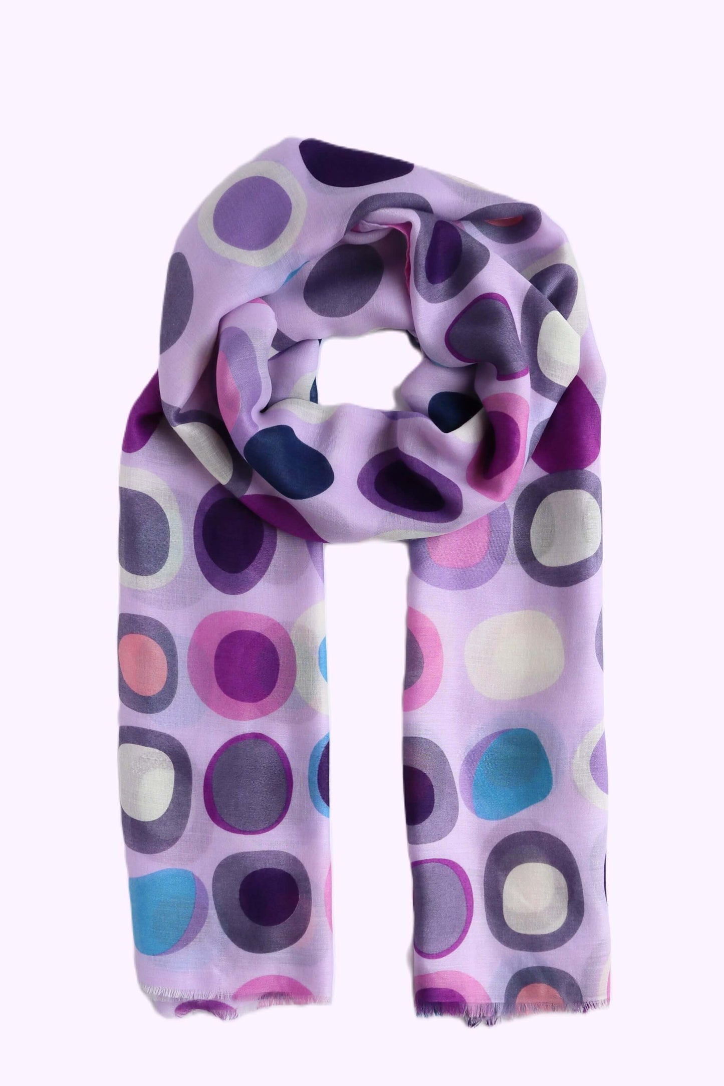 Light purple scarf with a retro-inspired oval and circle pattern in shades of purple, pink, and blue. Soft, lightweight fabric with a subtle fringe.