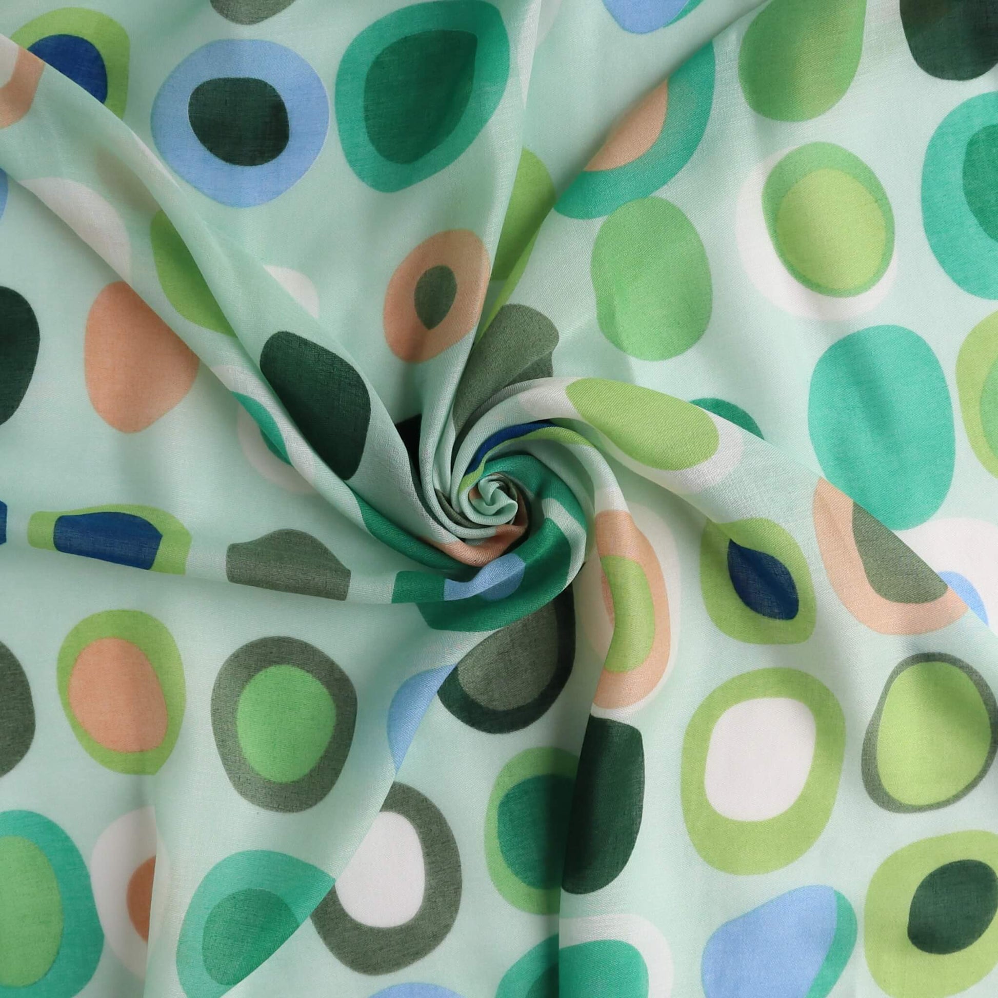 Pale aqua scarf fabric with a fun circle and oval pattern in green, peach, blue, and white. Sheer, breezy textile with a central swirl.