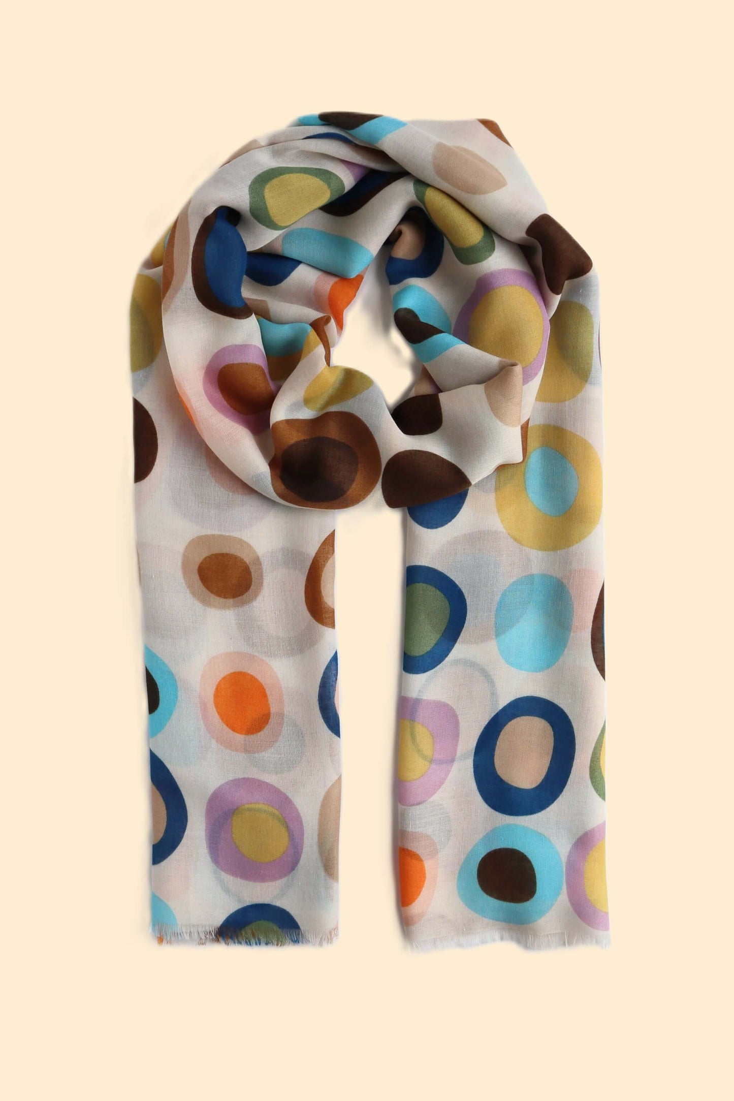 Beige scarf with a retro-style oval and circle pattern in brown, blue, green, orange, and lilac. Soft, lightweight fabric with a subtle fringe.
