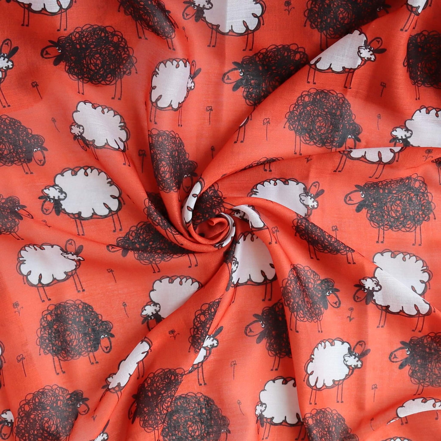 Vibrant red scarf fabric with a whimsical design of black and white sheep scattered across. Soft, draping material with gentle curves and folds.