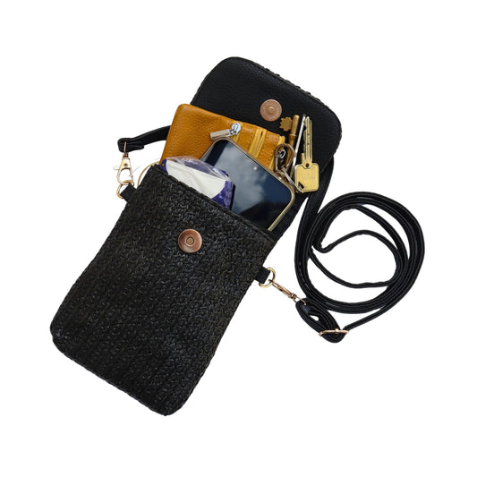 Aurora's Array: Open black woven crossbody phone bag revealing a yellow wallet, phone, keys, and tissues inside.