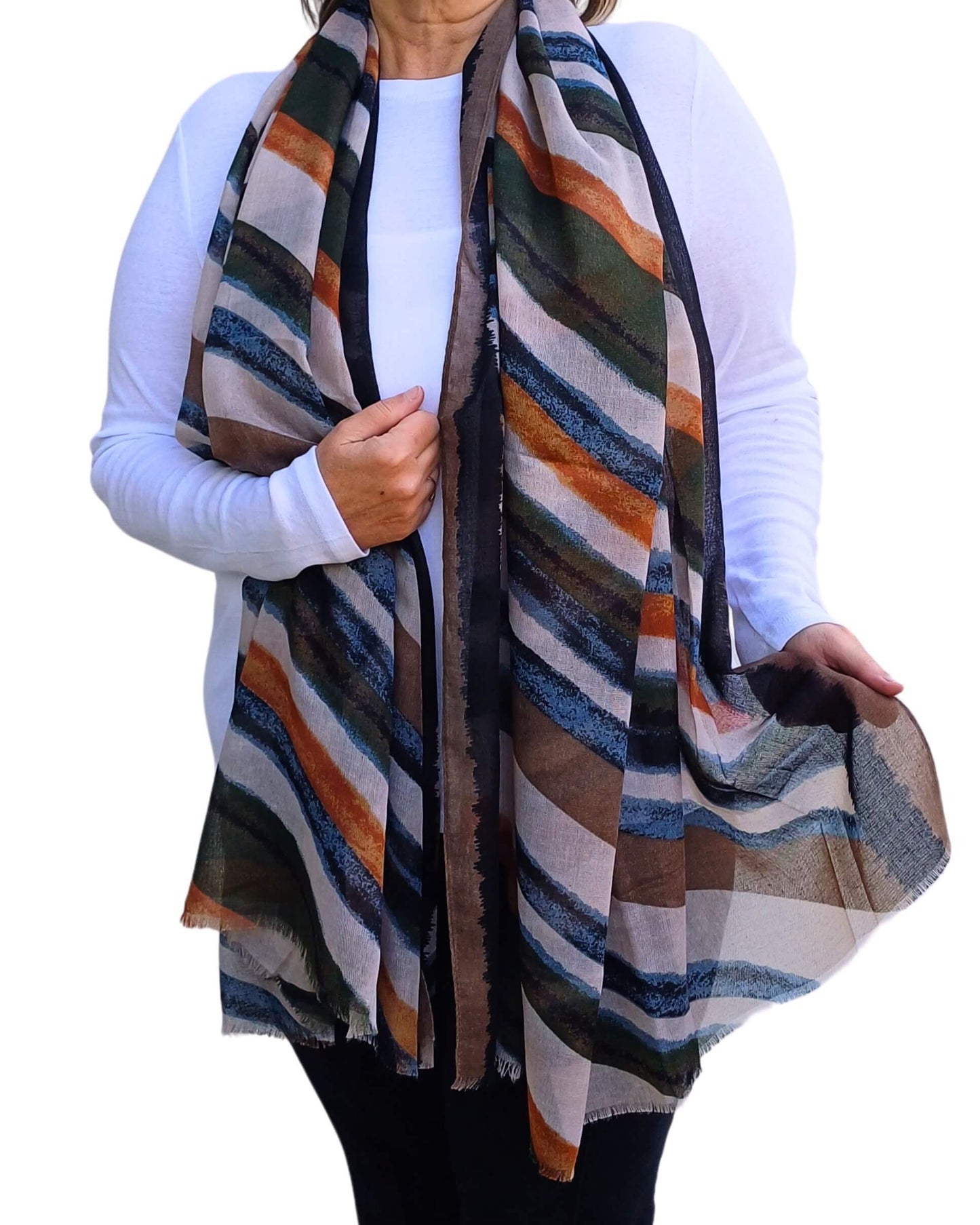 Aurora's Array: Woman models a soft, lightweight oversized scarf with diagonal stripes in muted shades of green, orange, brown, blue, and cream.