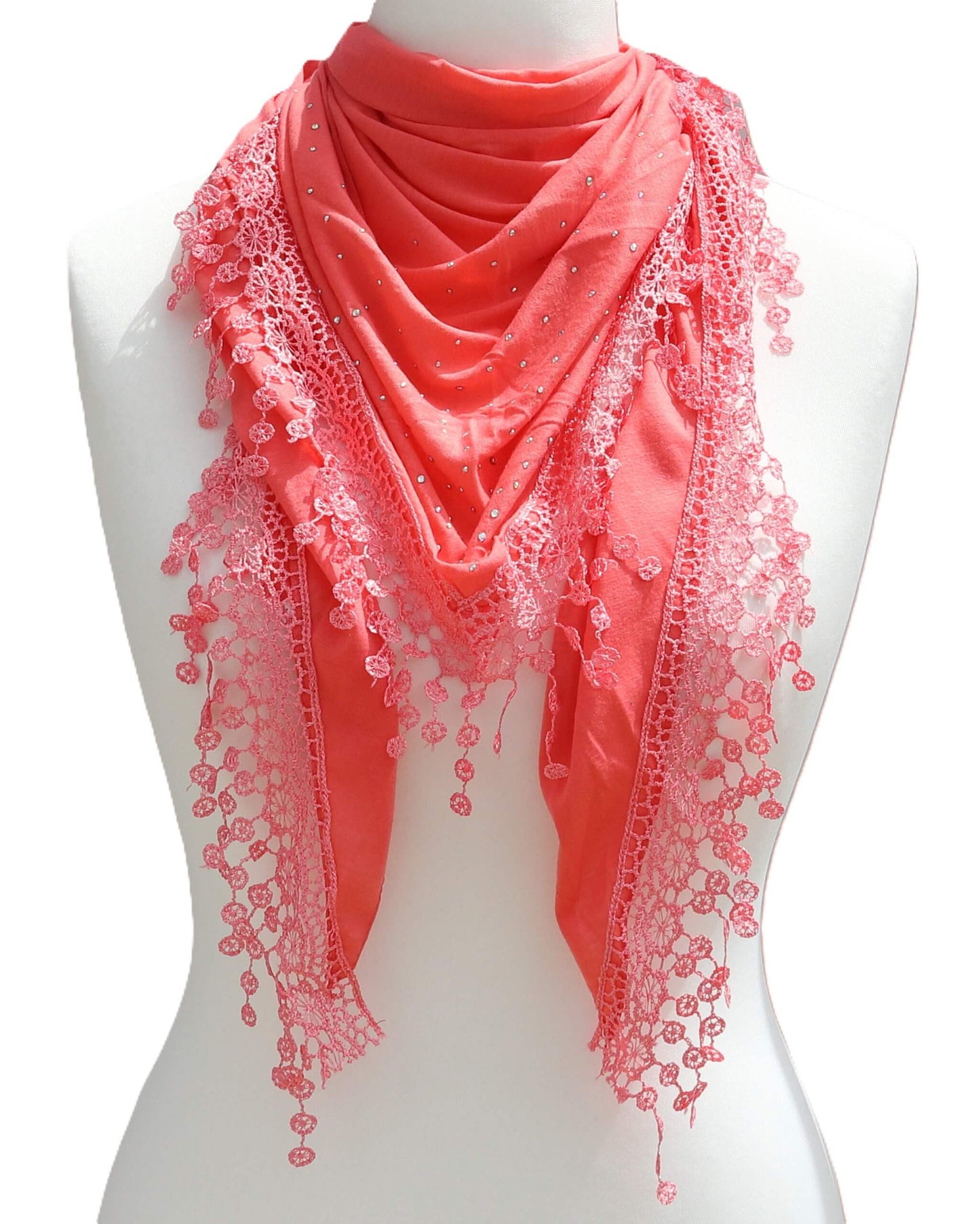 Aurora's Array: Coral soft lightweight triangle scarf with delicate lace trim and subtle silver embellishments, displayed on a mannequin.