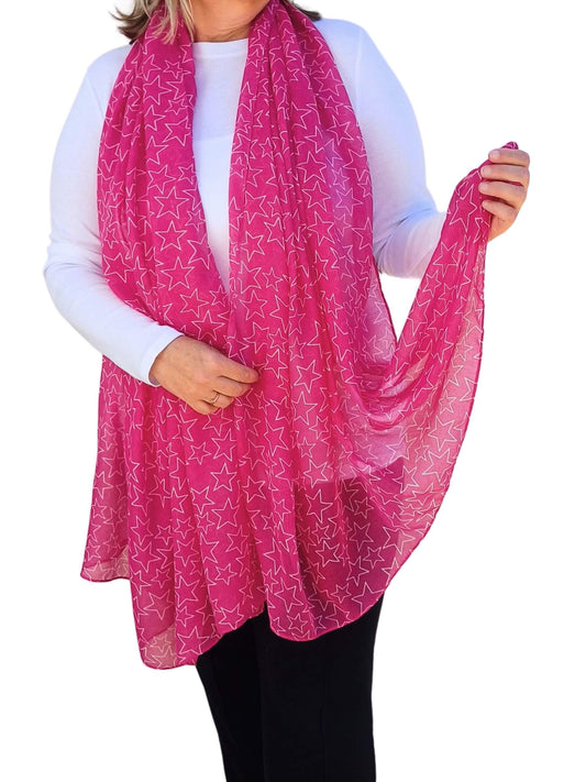 Aurora's Array: Woman models a soft, lightweight bright pink scarf with a subtle white star print.