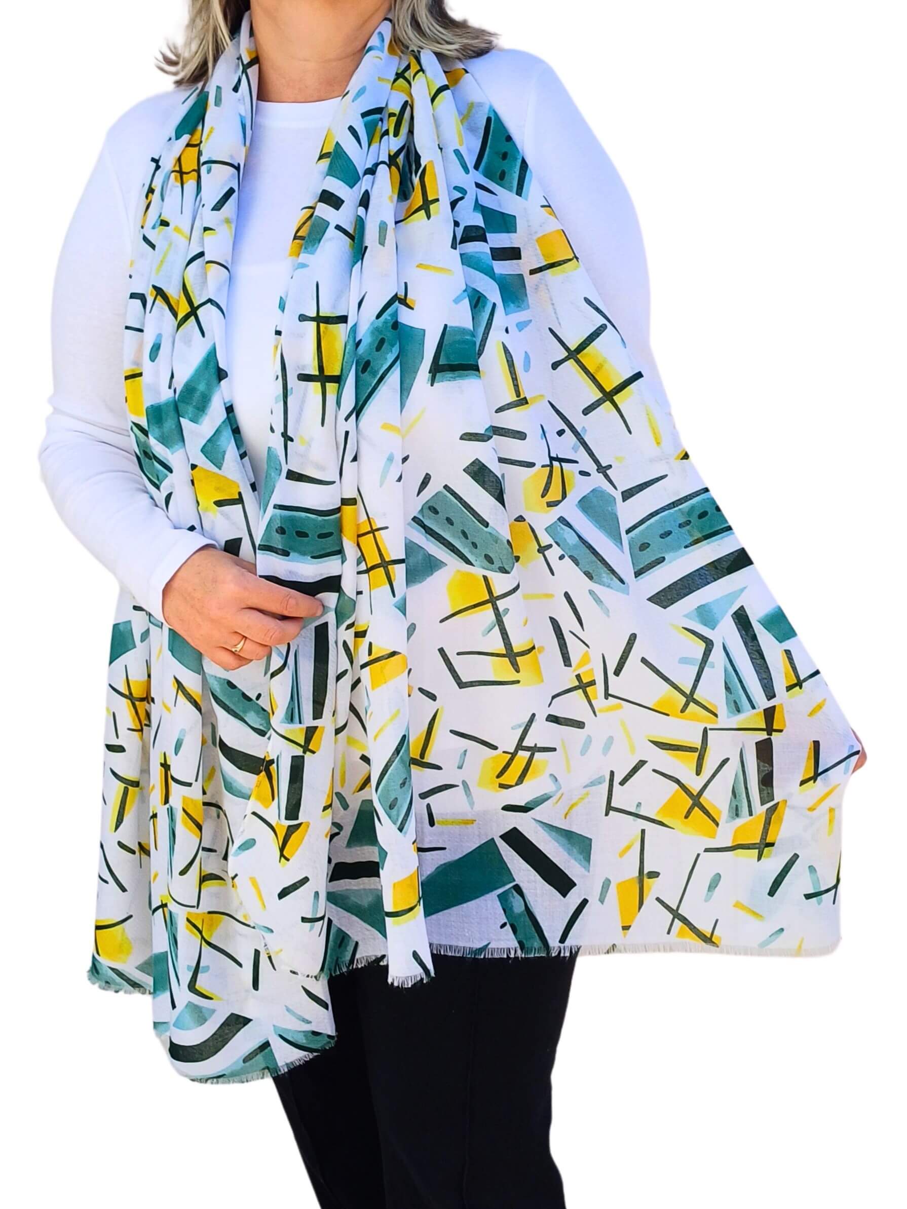 Aurora's Array: Woman models a soft, lightweight scarf with a modern abstract print in white, yellow, green, and black.