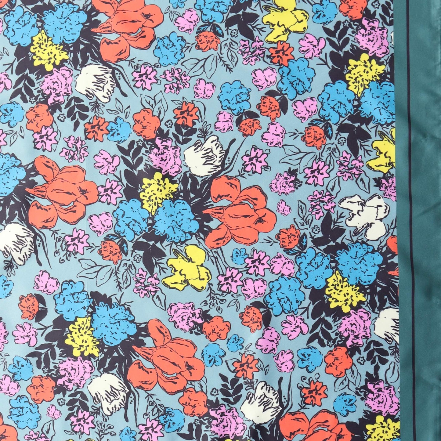 Aurora's Array: Close-up of a small square satin scarf with a vibrant floral print in shades of pink, yellow, blue, orange, and white on a light blue background, featuring a dark teal border on the right edge.