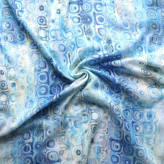 Light blue scarf fabric with a retro geometric circle print in varying blue and white hues. Soft, lightweight material.