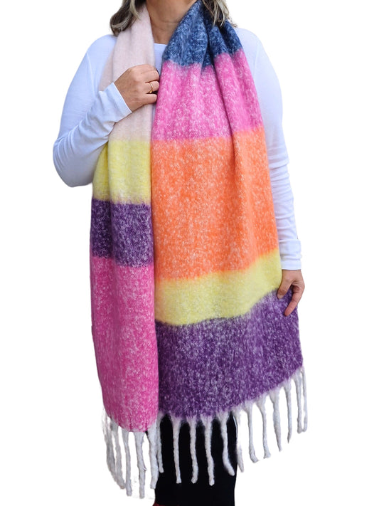 Aurora's Array: Model showcases a soft, oversized blanket scarf with bold horizontal stripes in various bright colours and a fringed edge.