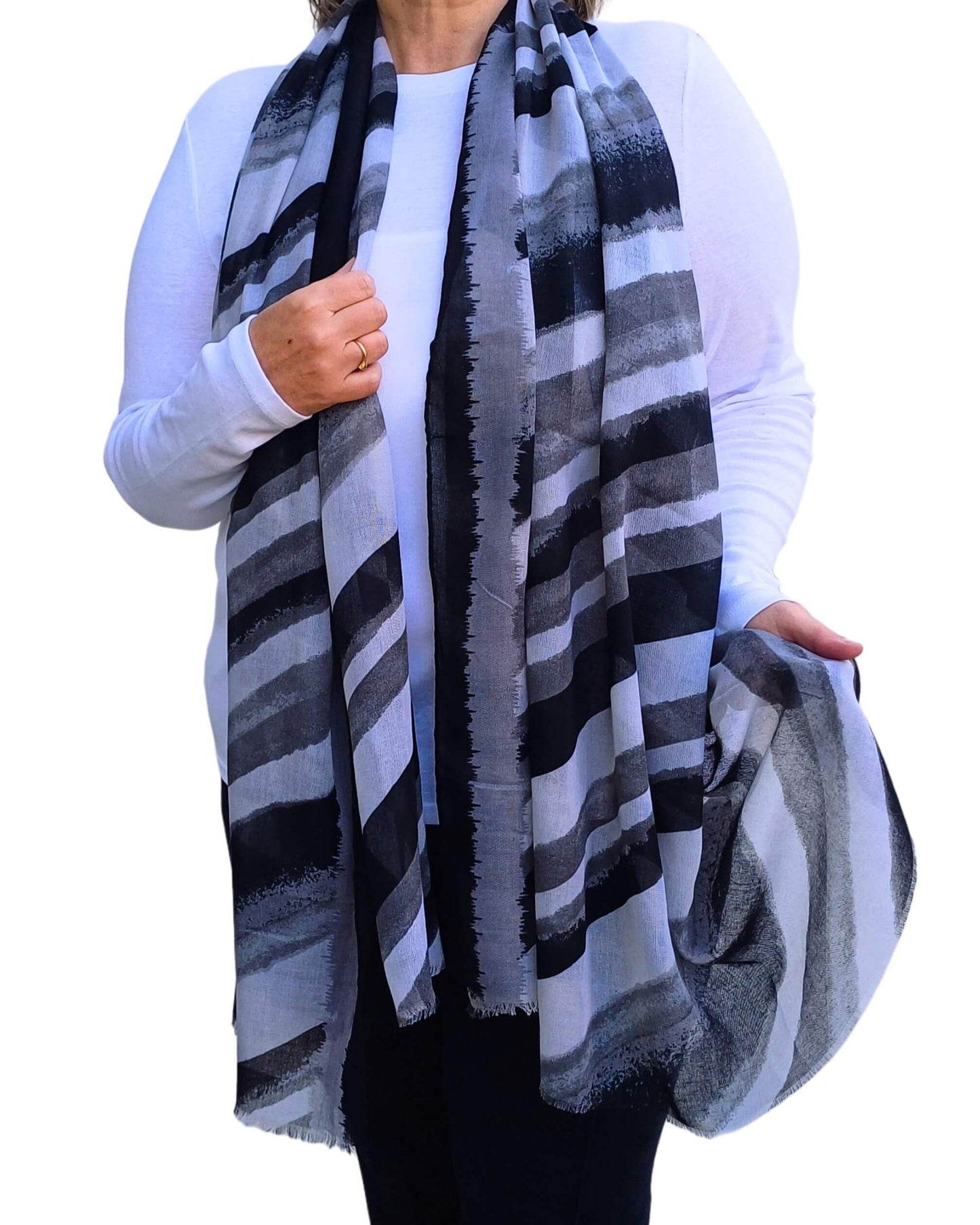 Aurora's Array: Woman models a soft, lightweight oversized scarf with diagonal stripes in black, grey, and white.
