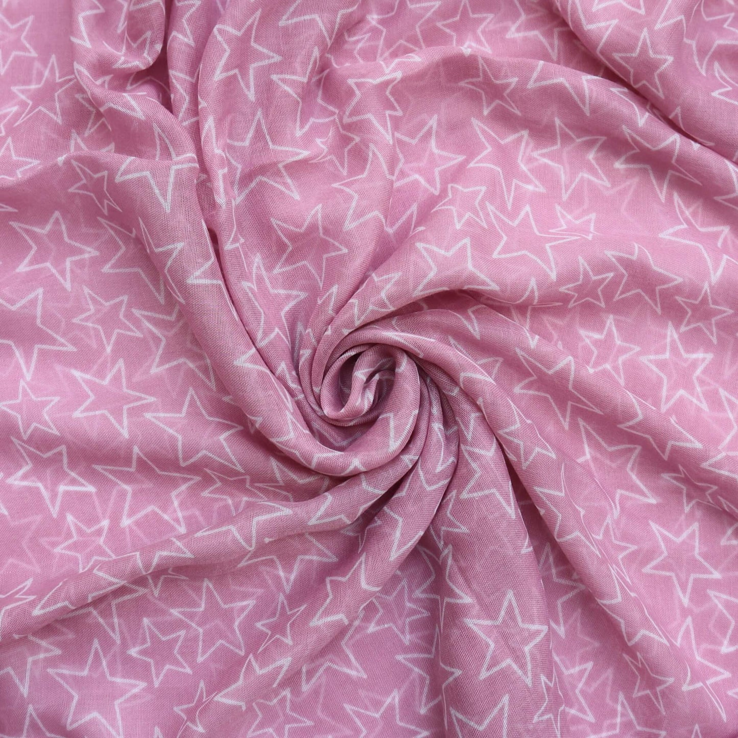 Aurora's Array: Close-up of a soft, lightweight dusky pink scarf with a subtle white star print, swirled to show detail.