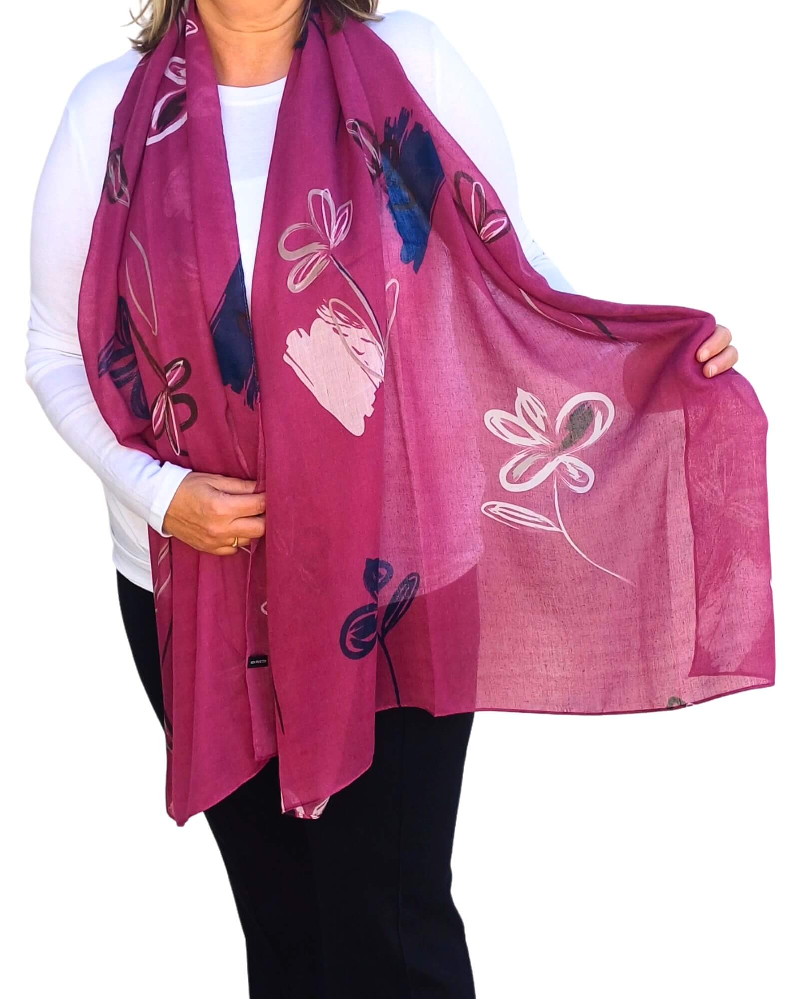 Aurora's Array: Woman models a soft, lightweight oversized scarf with an abstract floral print in shades of deep pink, white, navy, and light pink.
