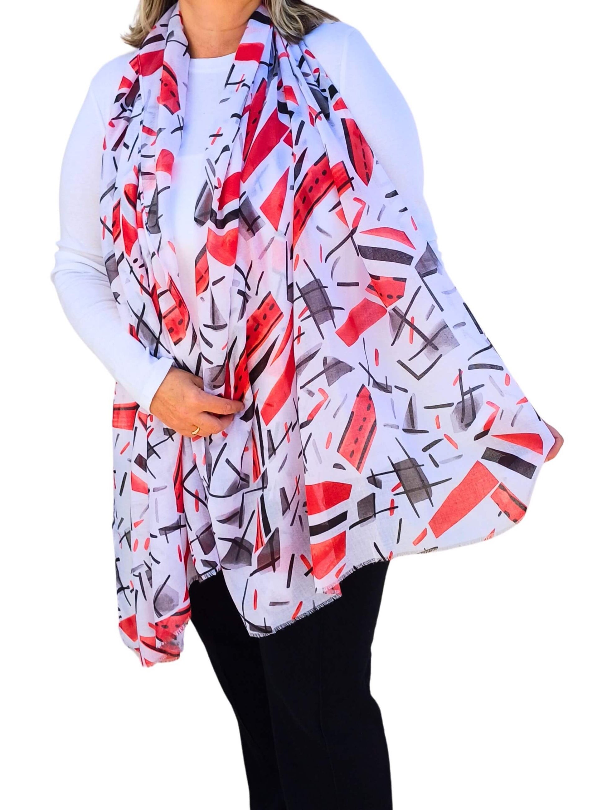 Aurora's Array: Woman models a soft, lightweight scarf with a modern abstract print in white, red, and black.