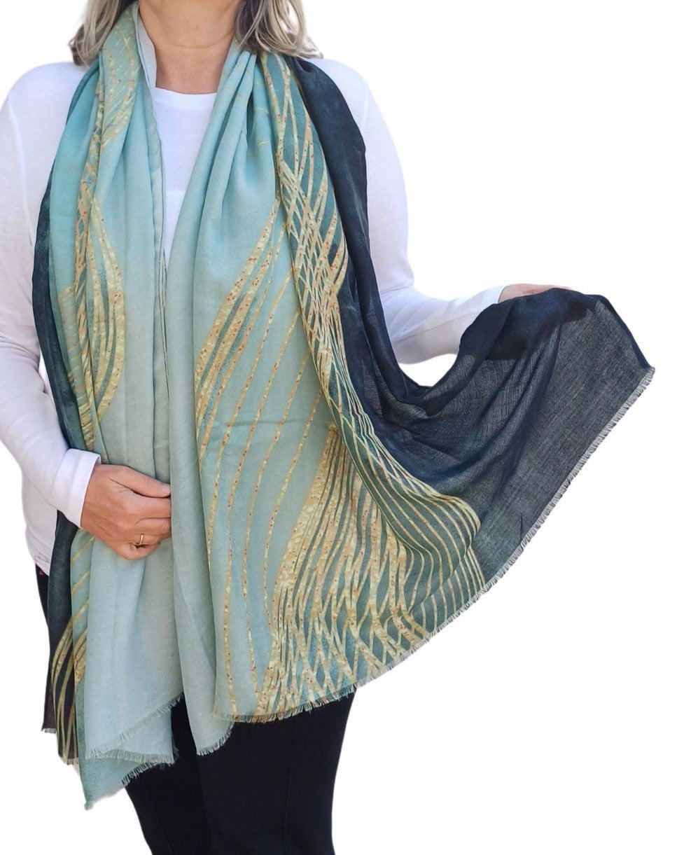 woman wearing teal fine stripe lightweight scarf with gold swirl design and soft sheer fabric