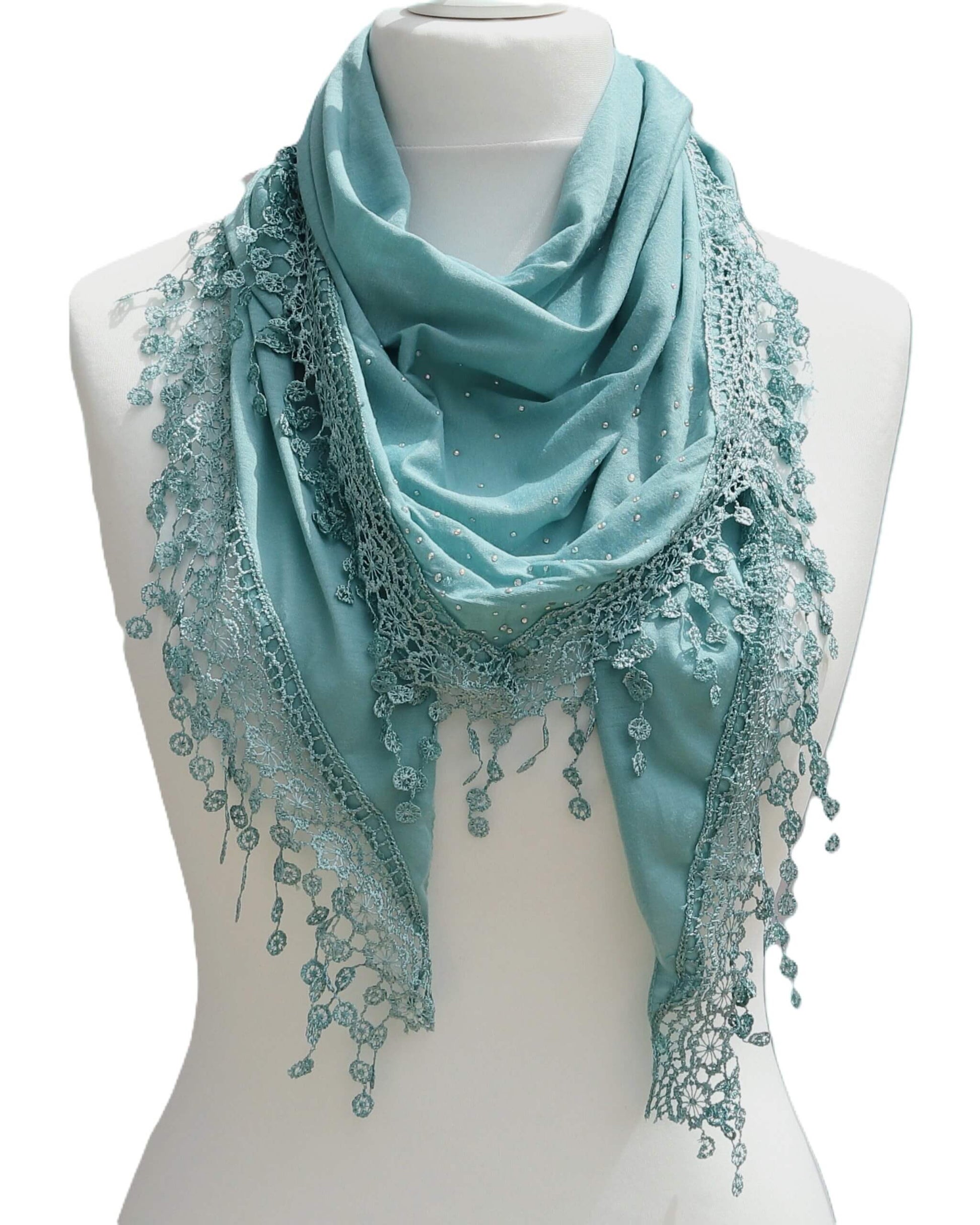 Aurora's Array: Teal green lightweight triangle scarf with lace-style trim and tiny sparkles, displayed on a mannequin.