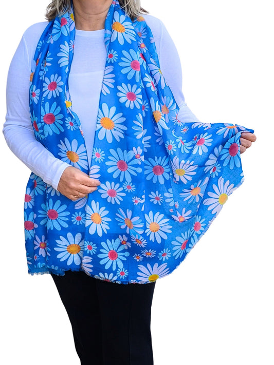 Bright blue scarf with a cheerful daisy pattern in white, yellow, and pink. Lightweight and stylish accessory.