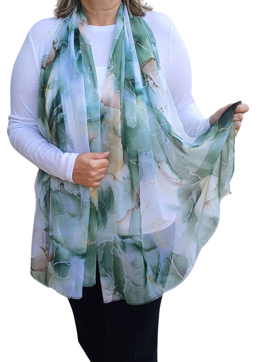 Lightweight summer scarf with a flowing marble print in shades of green, blue, and cream. Elegant and airy accessory.