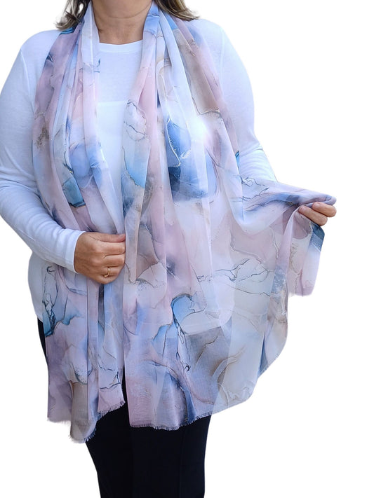 Airy summer scarf with a delicate marble design in shades of blue, pink, and cream, featuring subtle gold foil accents. Lightweight and stylish.