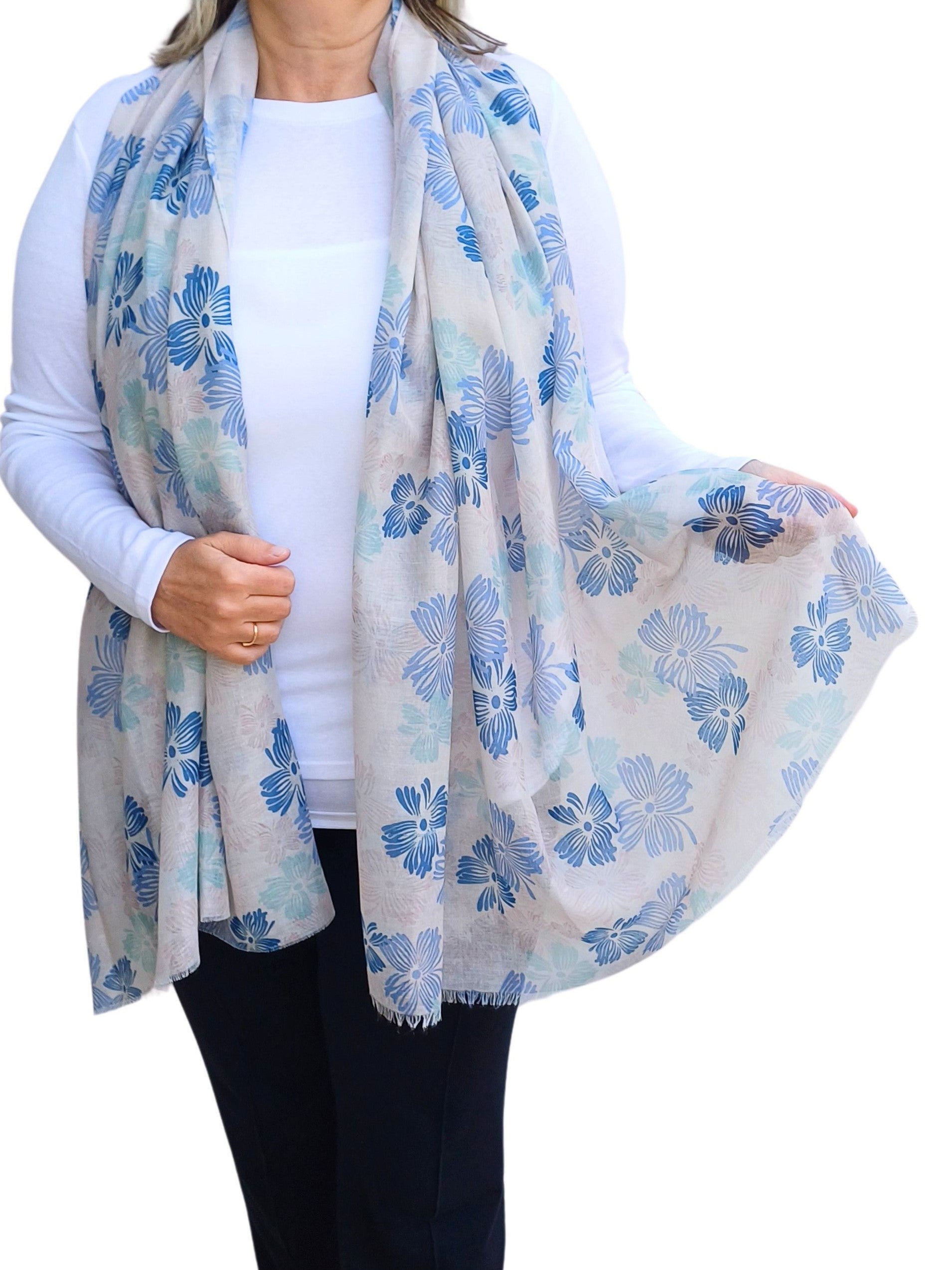 Aurora's Array: Woman models a lightweight pale grey scarf with a blue floral print.