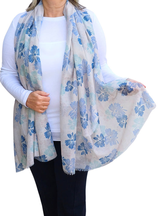Aurora's Array: Woman models a lightweight pale grey scarf with a blue floral print.