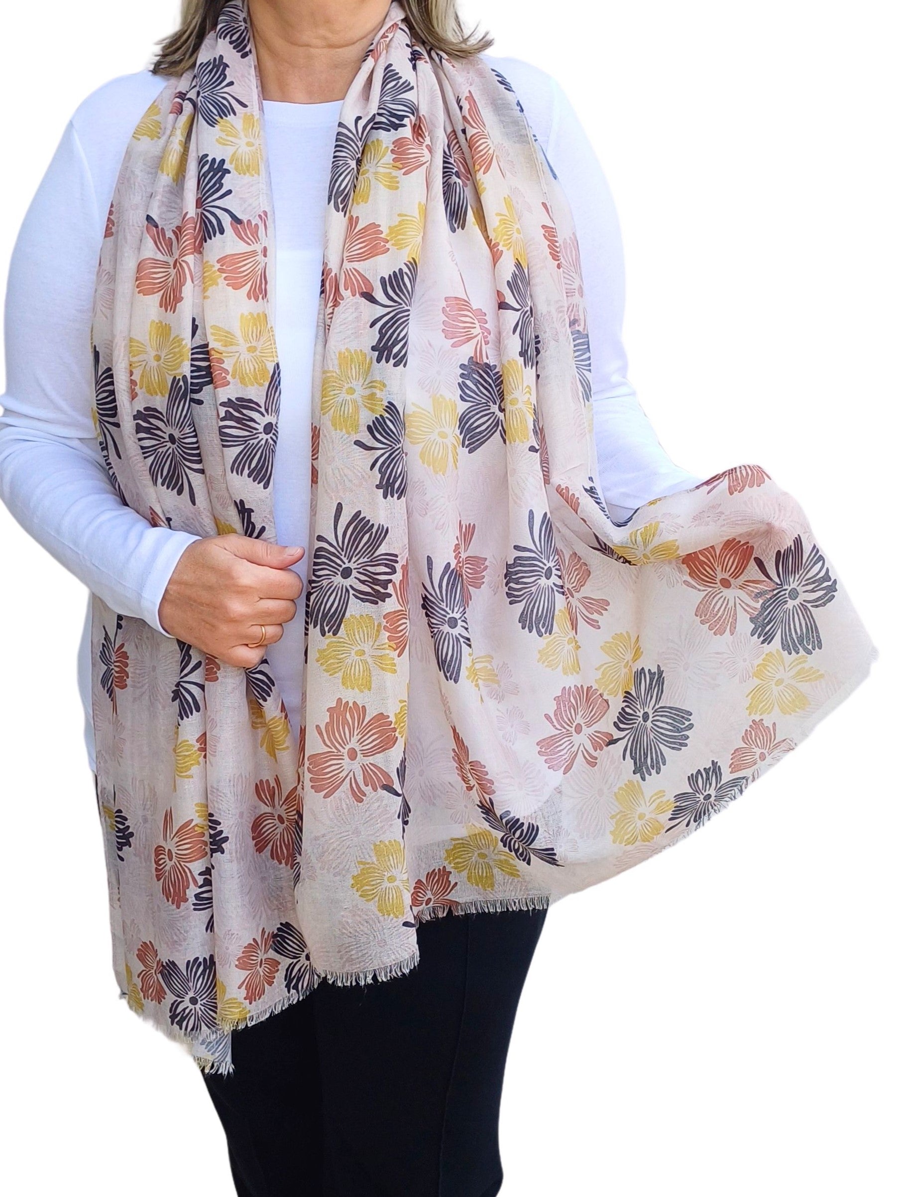 Aurora's Array: Woman models a lightweight cream scarf with a vintage-inspired floral print in shades of black, red, and yellow.