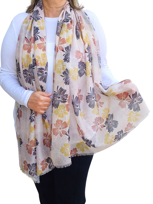 Aurora's Array: Woman models a lightweight cream scarf with a vintage-inspired floral print in shades of black, red, and yellow.