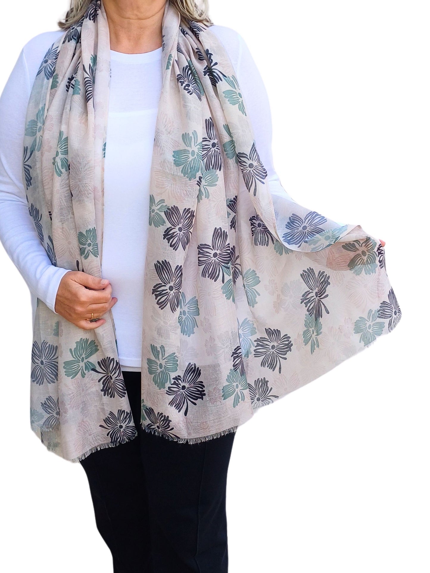 Aurora's Array: Woman models a lightweight scarf with a floral print in shades of grey, blue, and green.