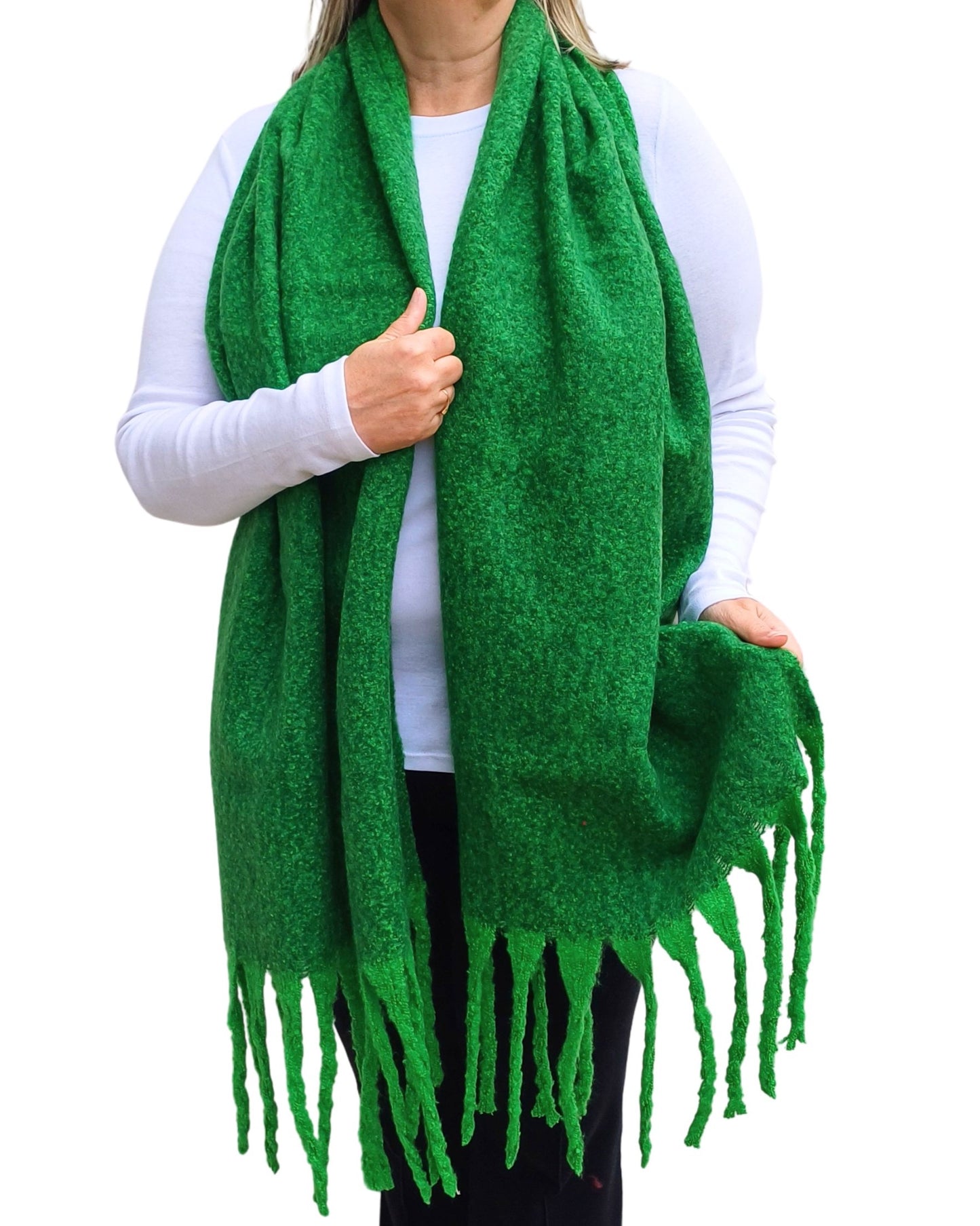 Aurora's Array: Woman models a soft, textured bright green knit scarf with long fringe.