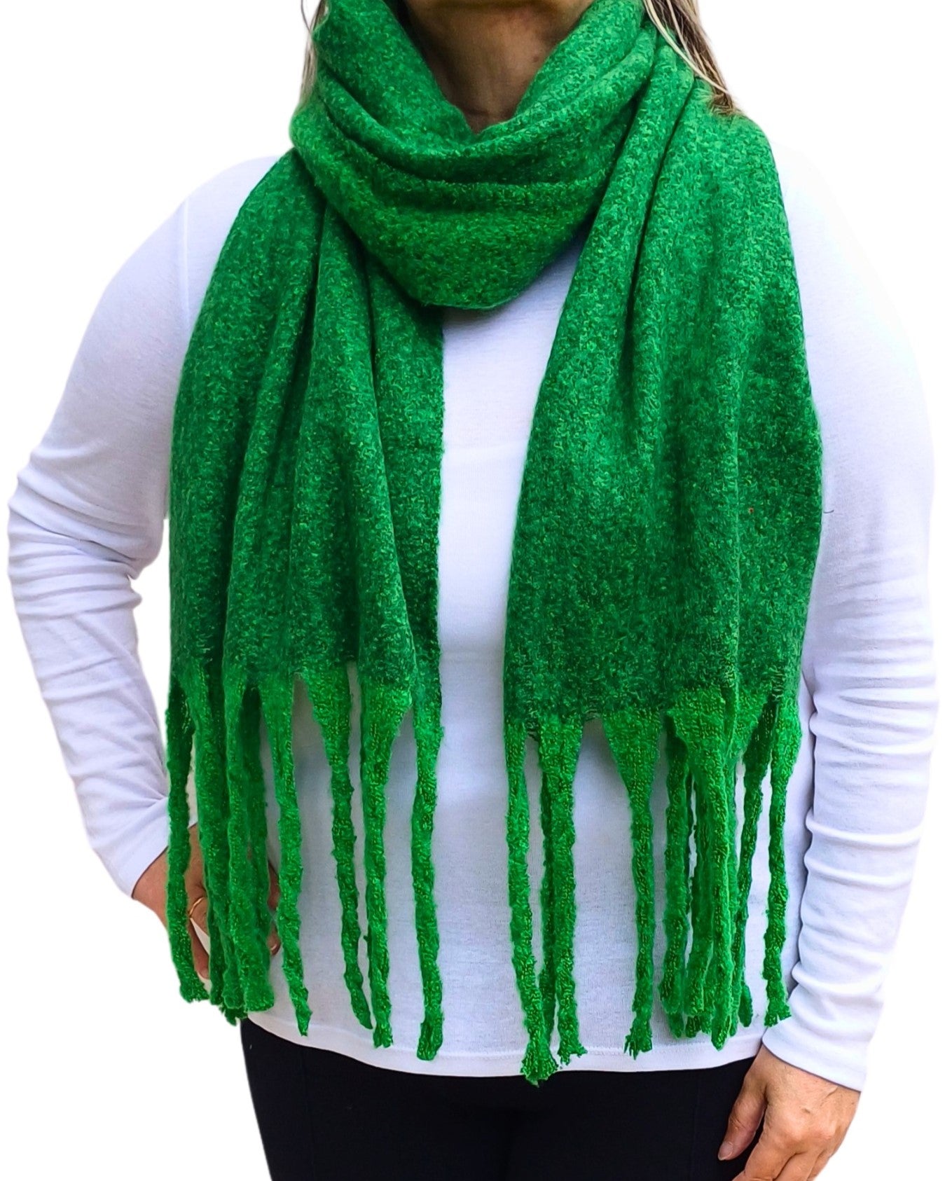 Aurora's Array: Woman models a soft, textured bright green knit scarf with long fringe.