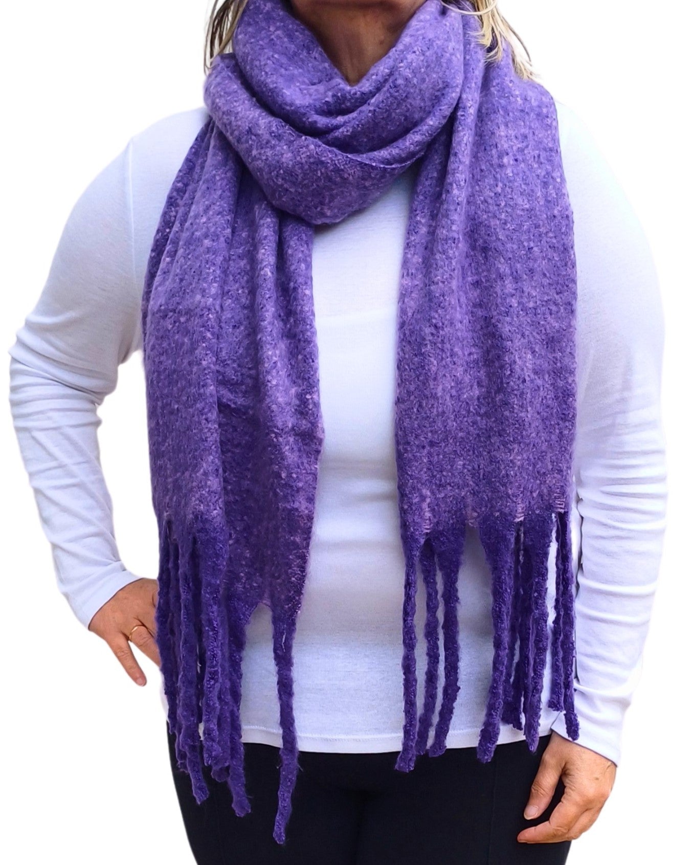 Aurora's Array: Woman models a soft, textured bright purple knit scarf with long fringe.