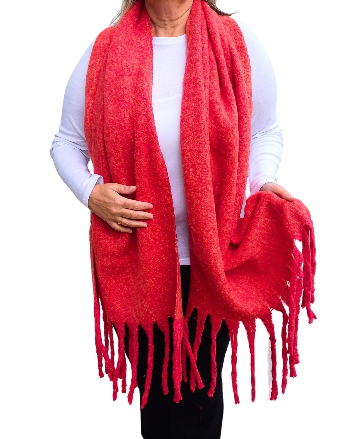 Aurora's Array: Woman models a soft, textured bright red knit scarf with long fringe.