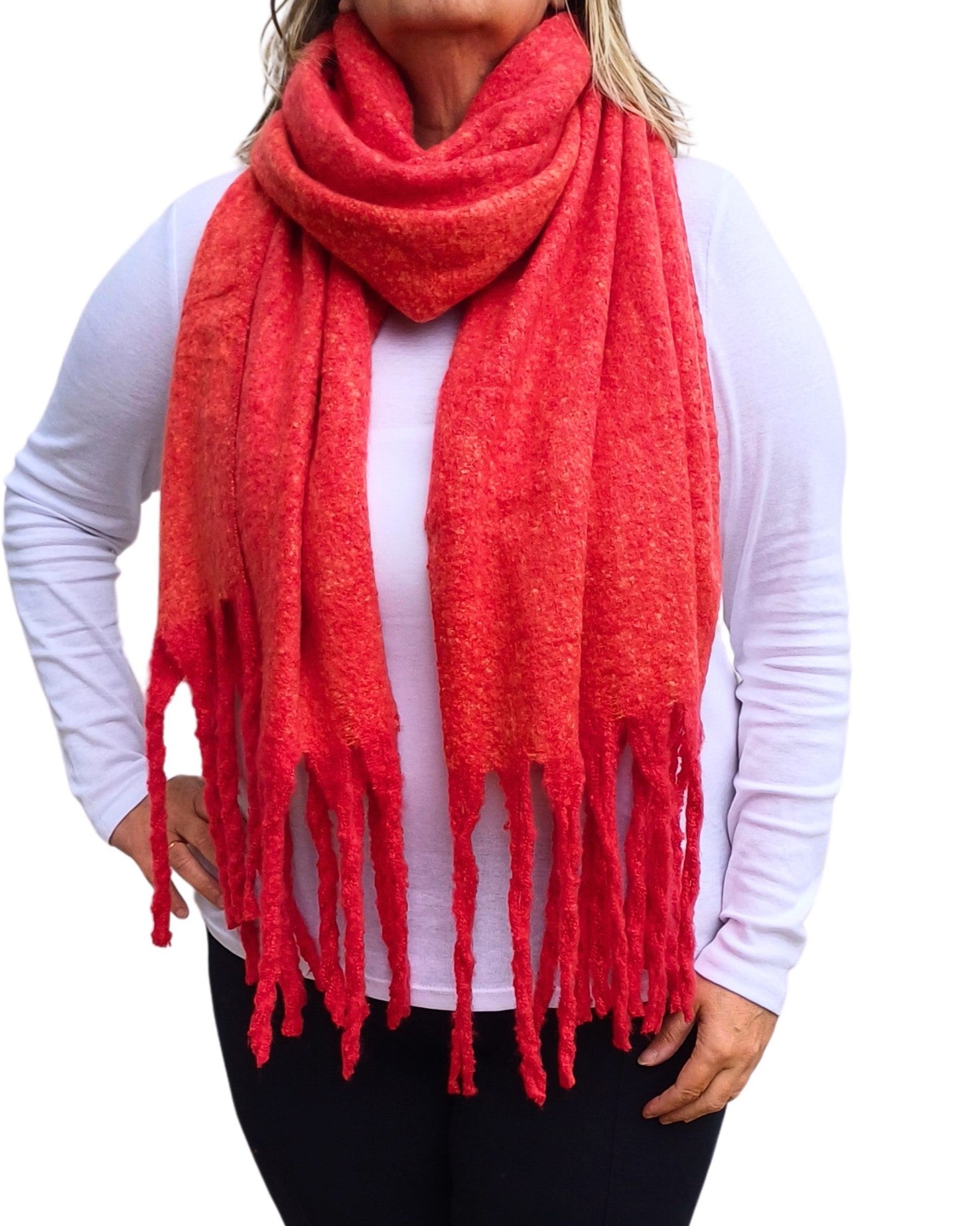 Aurora's Array: Woman models a soft, textured bright red knit scarf with long fringe.