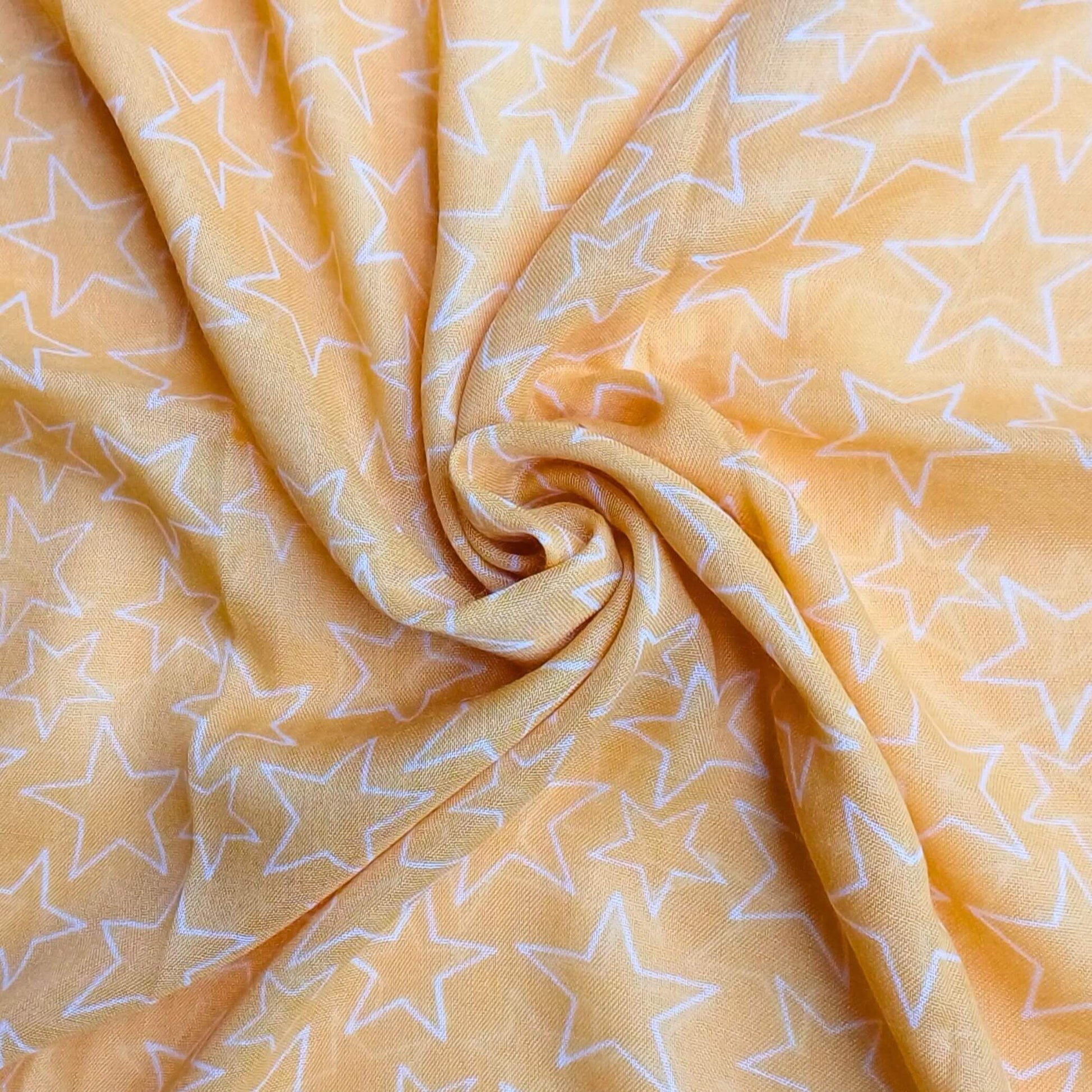 Aurora's Array: Close-up of a soft, lightweight yellow scarf with a subtle white star print, swirled to show detail.