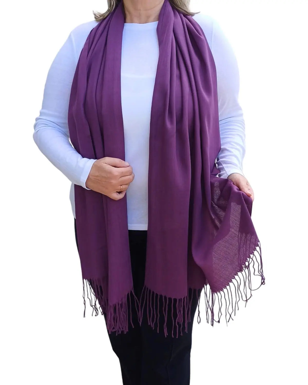 Model wearing aubergine purple pashmina shawl – soft lightweight wrap with tassels, UK brand