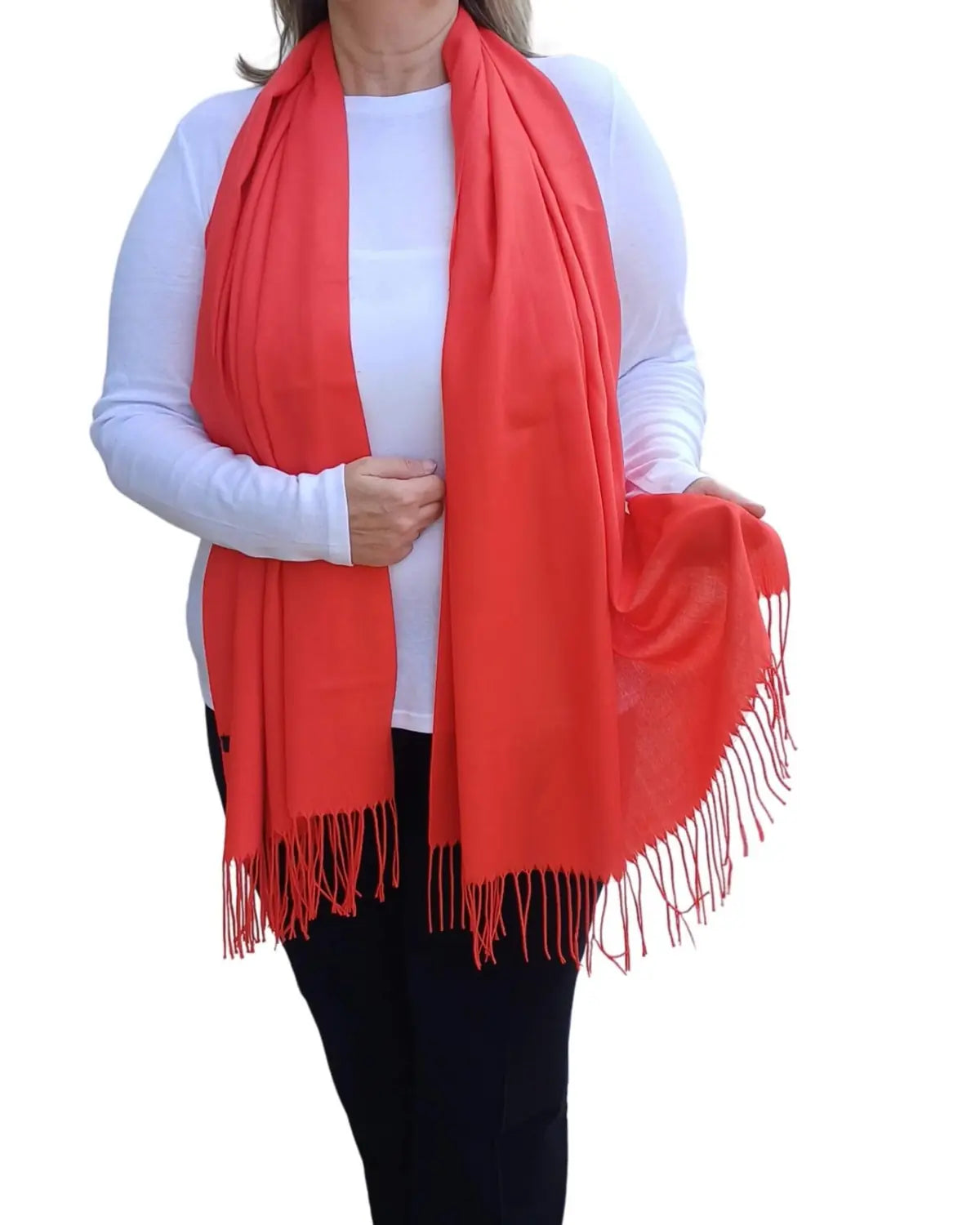 Model wearing bright red pashmina shawl – soft lightweight wrap with tassels, UK brand