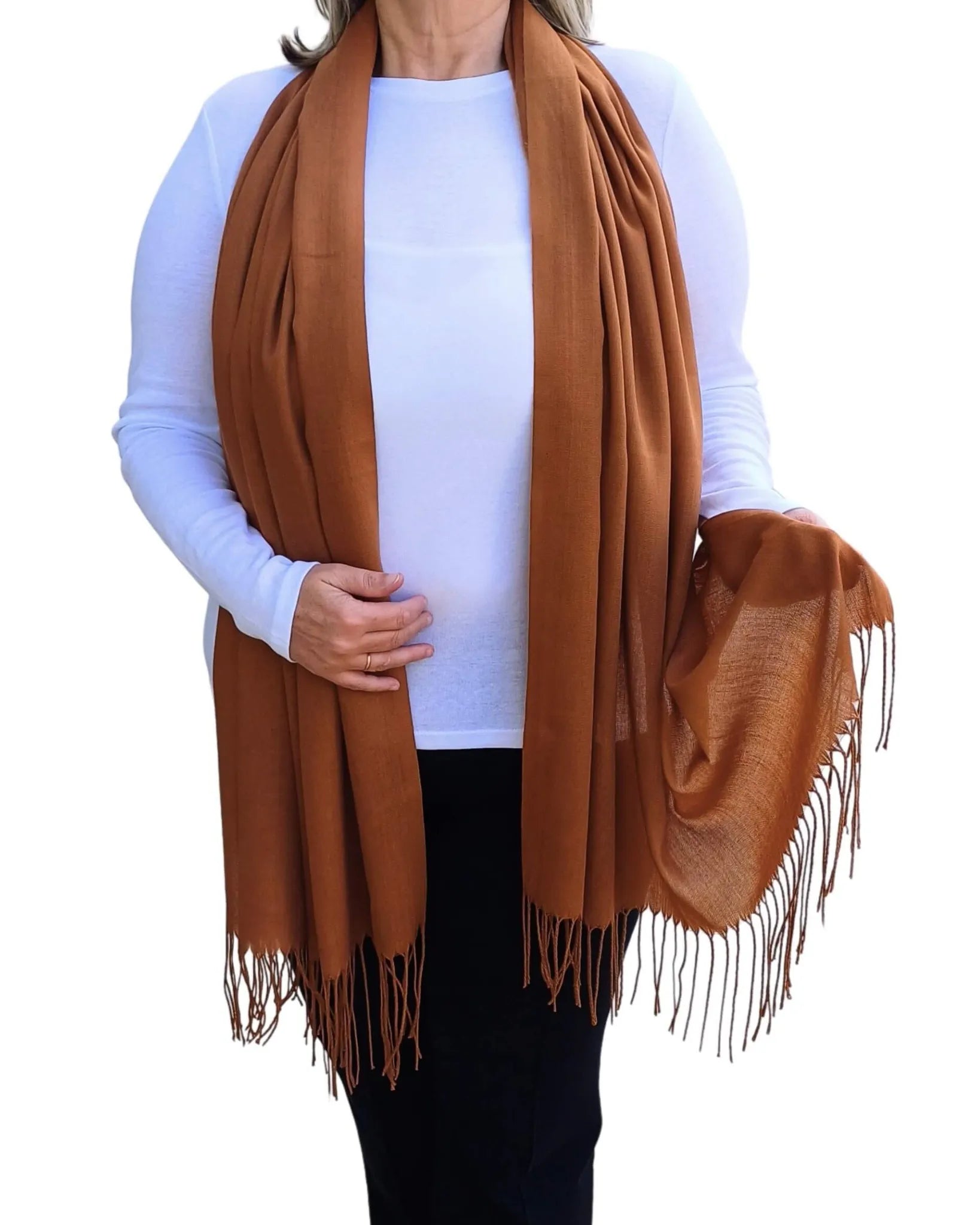 Model wearing camel brown pashmina shawl – soft lightweight wrap with tassels, UK brand