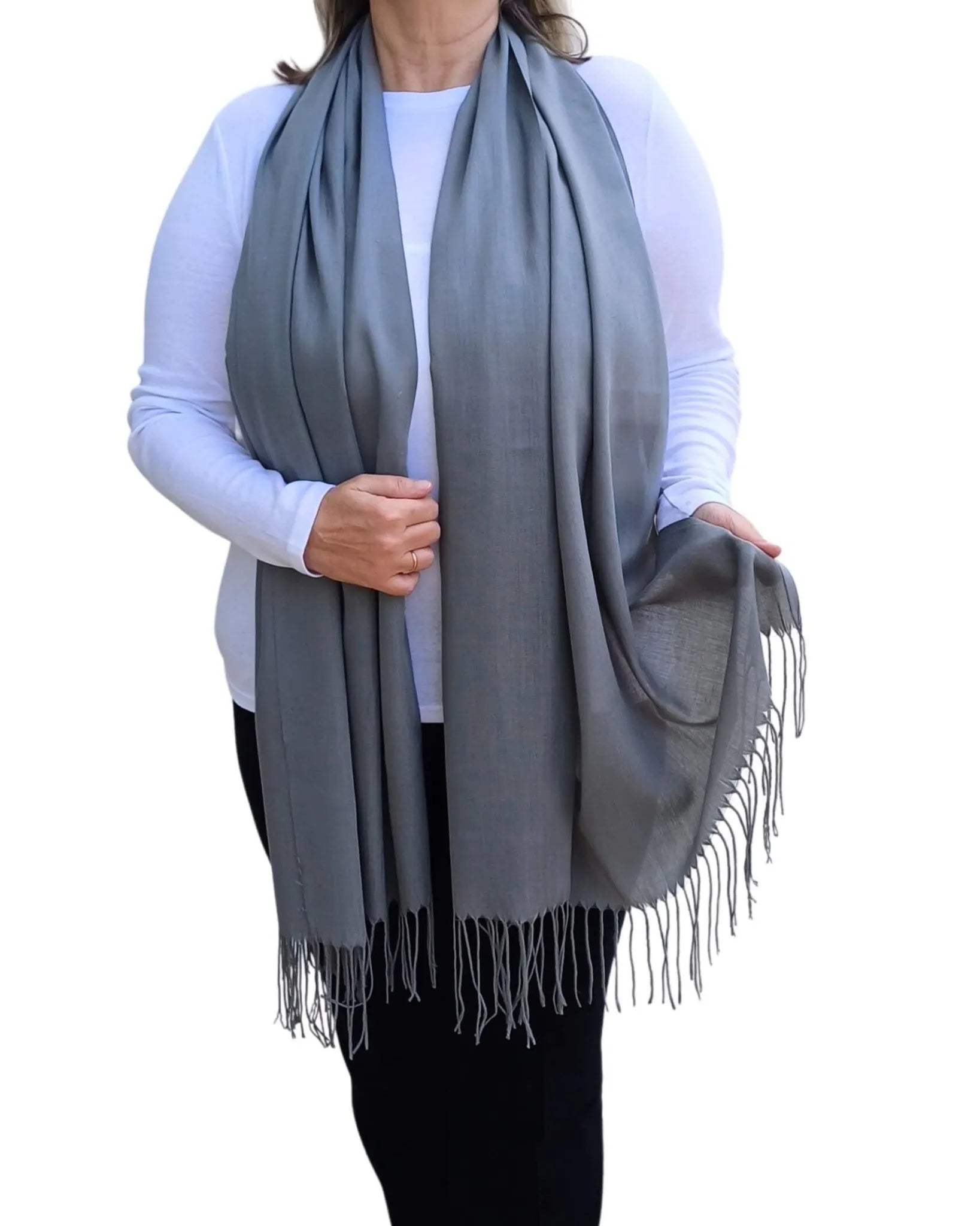 Model wearing dark grey pashmina shawl – soft lightweight wrap with tassels, UK brand