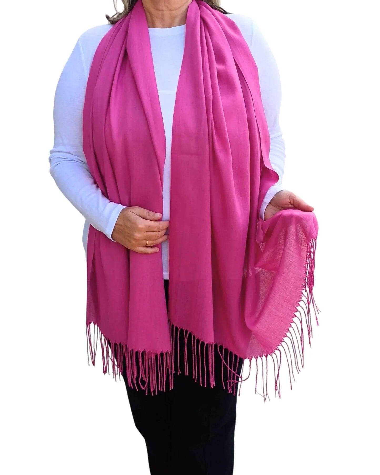 Model wearing hot pink pashmina shawl – soft lightweight wrap with tassels, UK brand