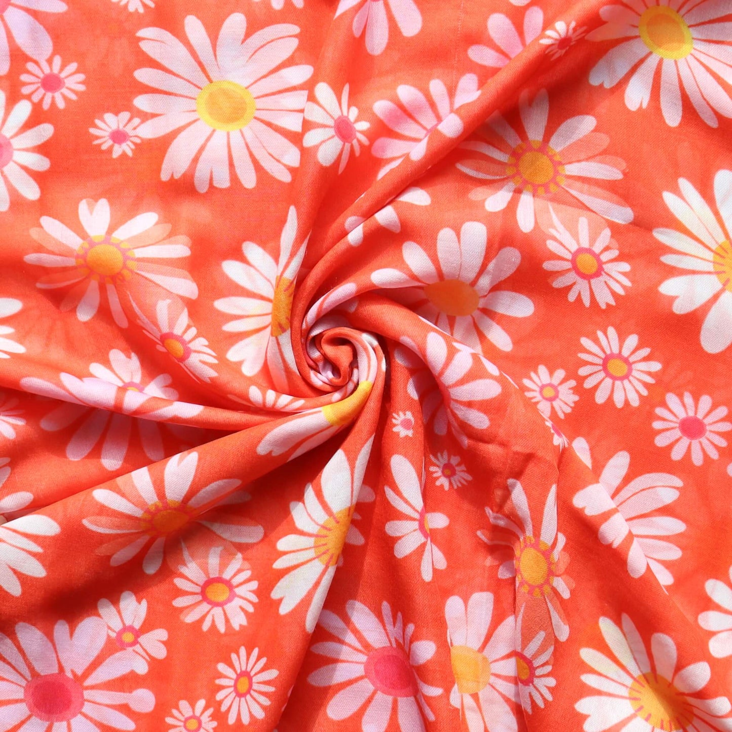 Vibrant orange scarf fabric with a cheerful daisy pattern in white, yellow, and pink. Lightweight and stylish material.