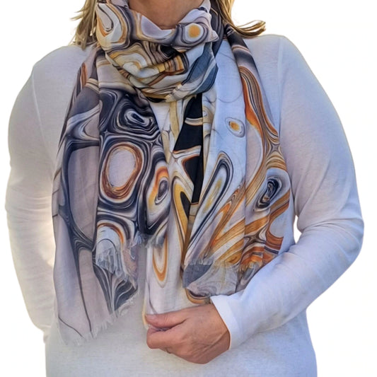 Lightweight marble style scarf in orange and grey shown wrapped around the neck