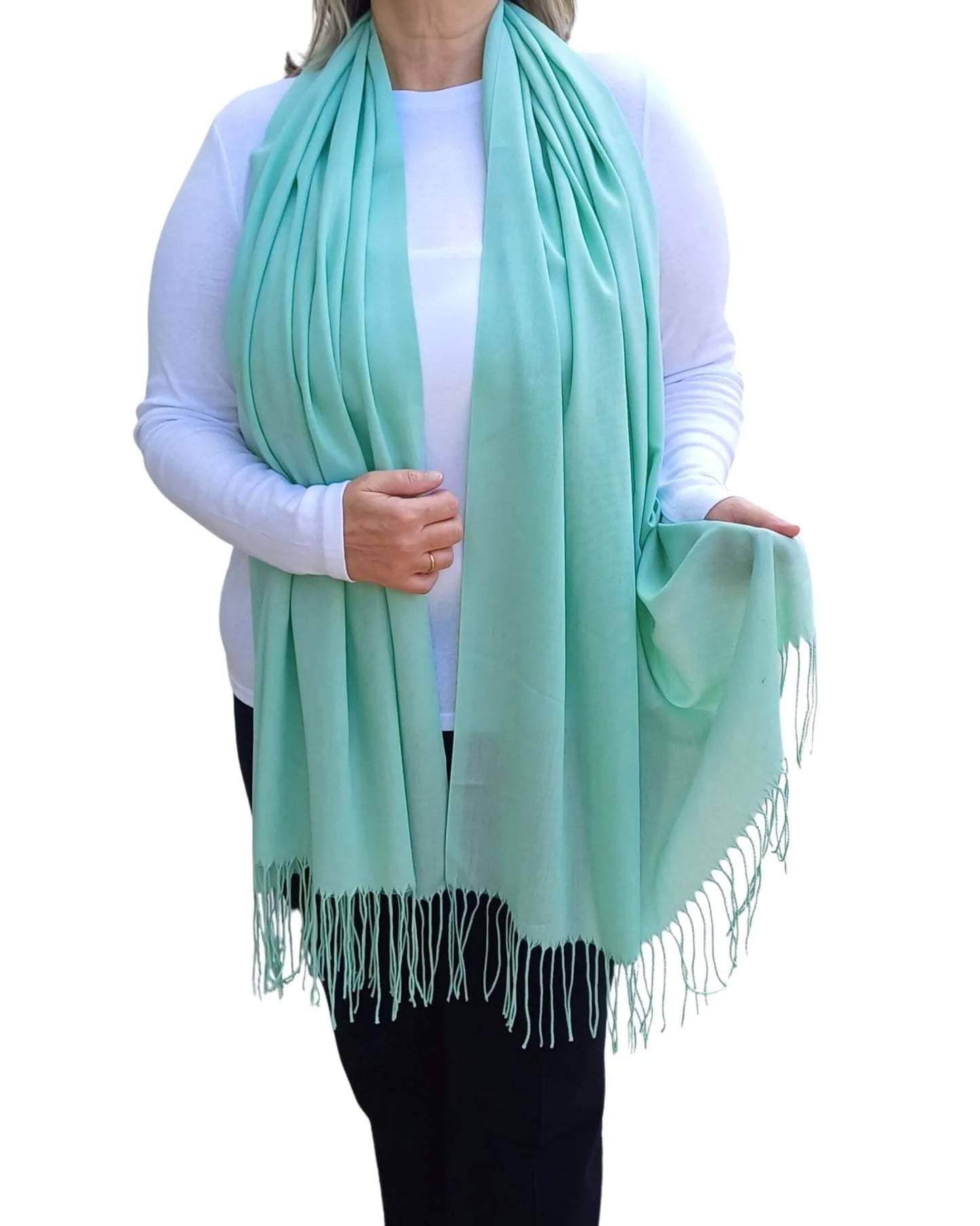 Model wearing mint green pashmina shawl – soft lightweight wrap with tassels, UK brand