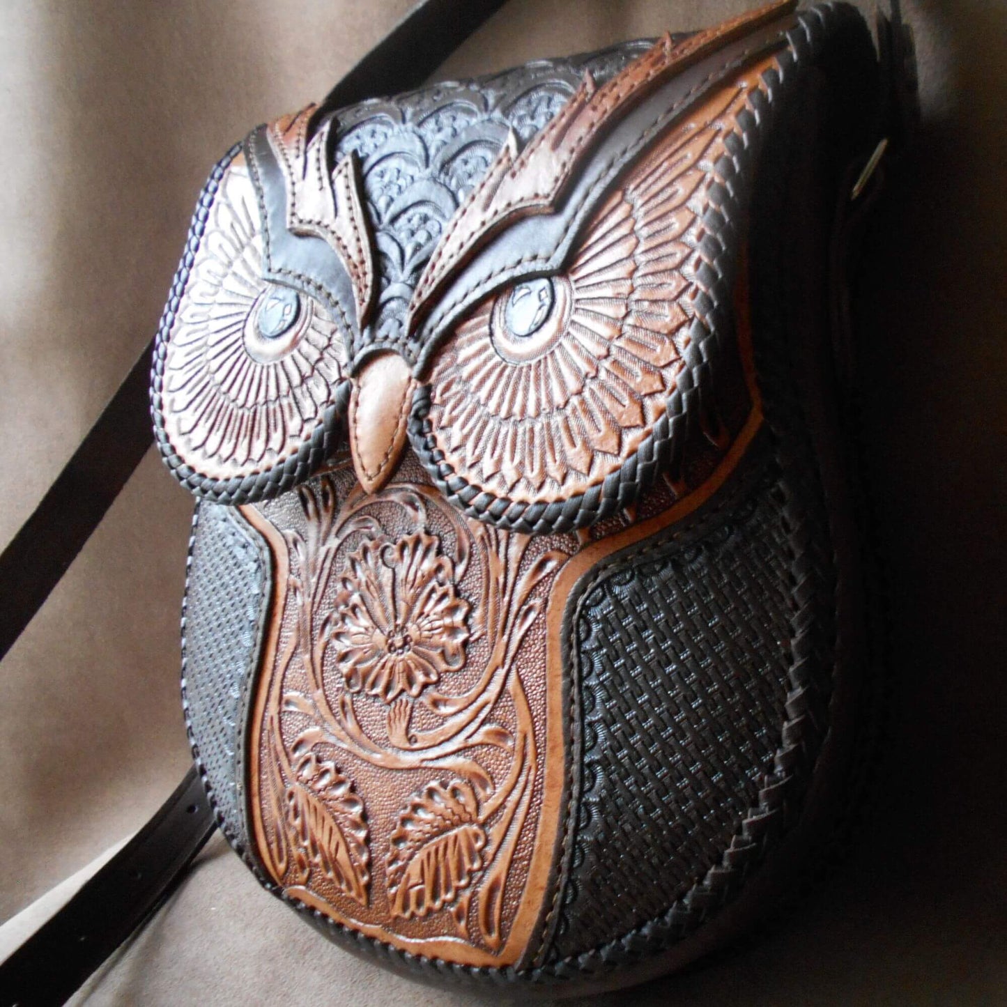 Angled view of owl-tooled leather bag with adjustable strap – Nox