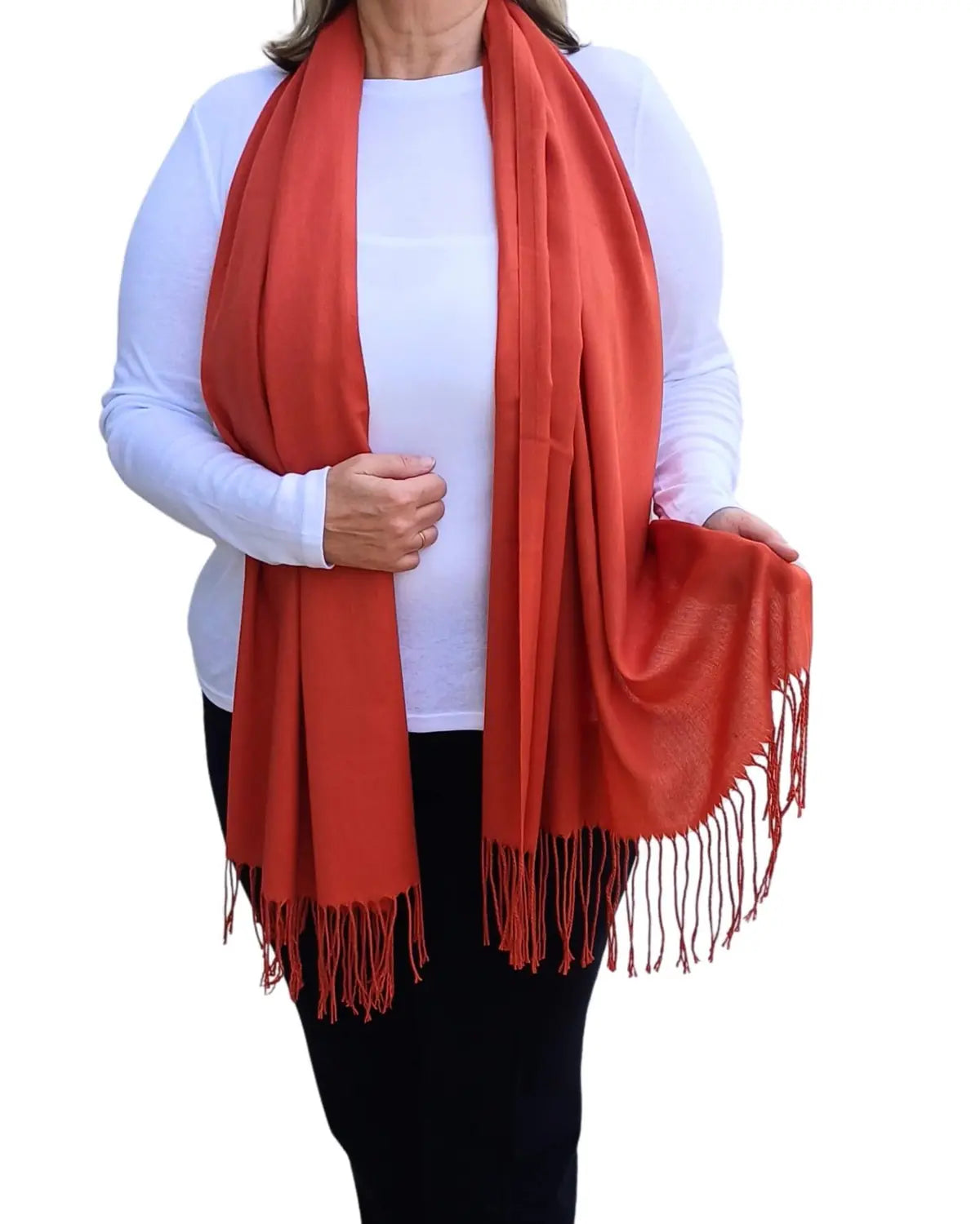 Model wearing orange red pashmina shawl – soft lightweight wrap with tassels, UK brand