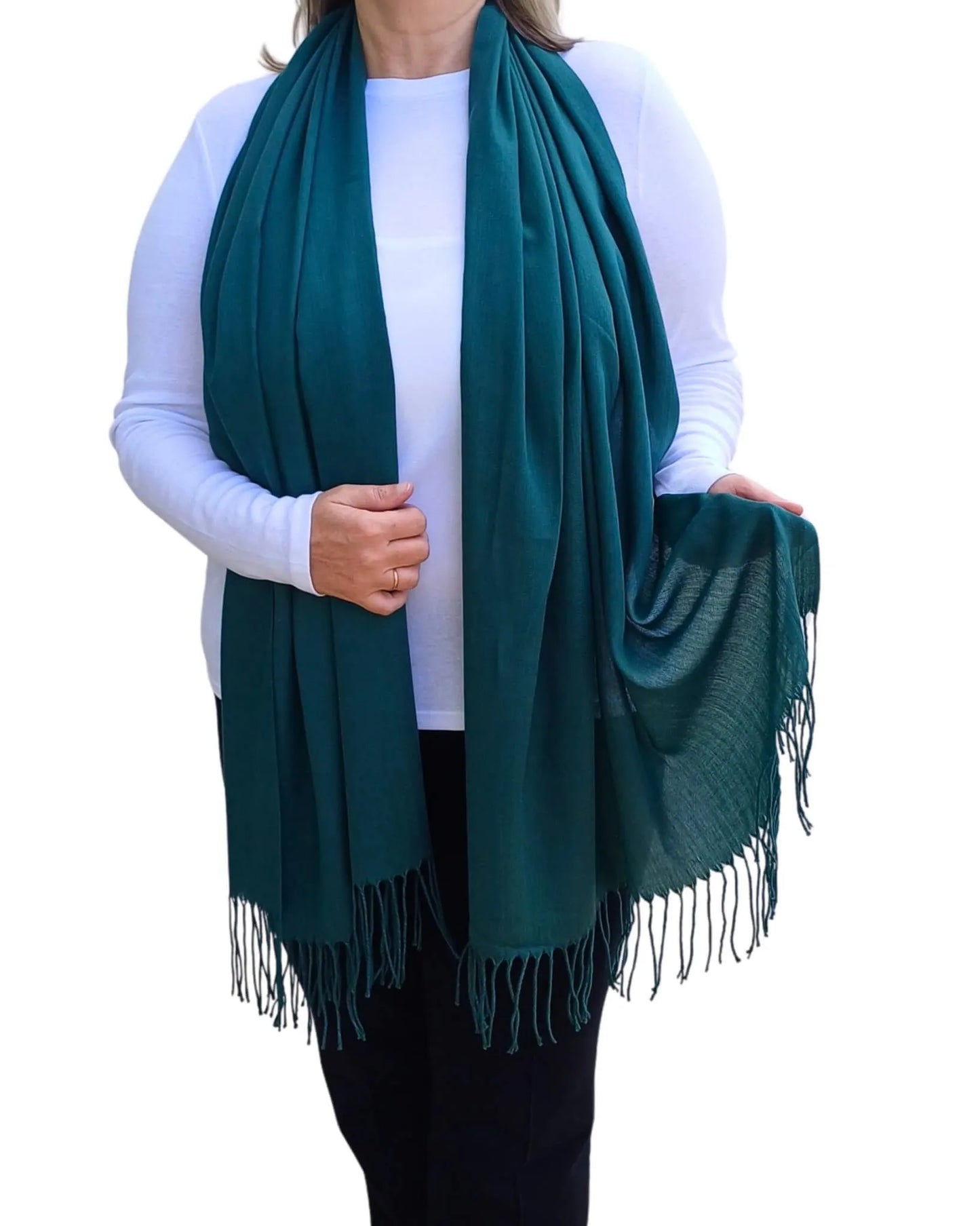 Model wearing petrol green pashmina shawl – soft lightweight wrap with tassels, UK brand