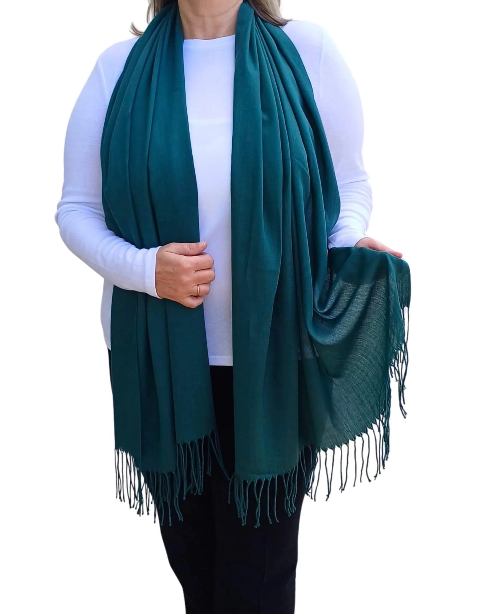Model wearing petrol green pashmina shawl – soft lightweight wrap with tassels, UK brand