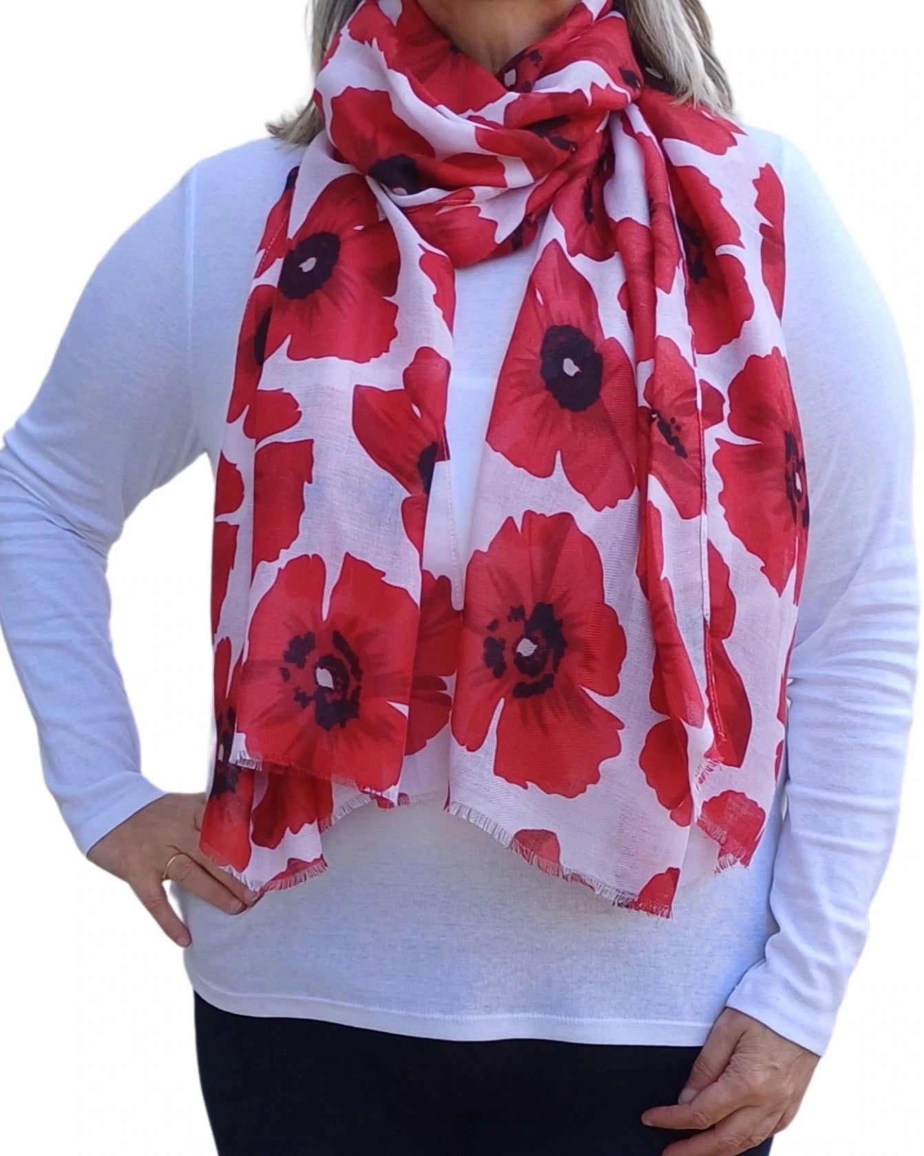 Red poppy print scarf styled around neck on model