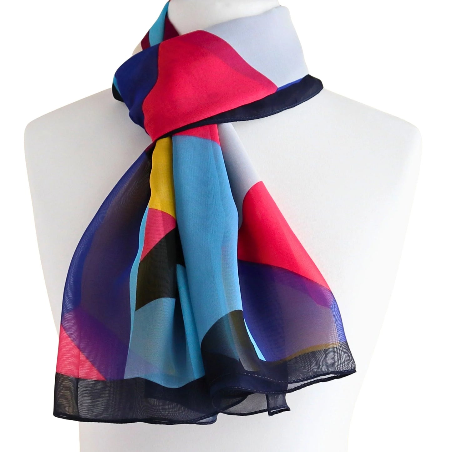 Lightweight chiffon-style scarf tied at the neck in in navy blue and bold colours geometric print