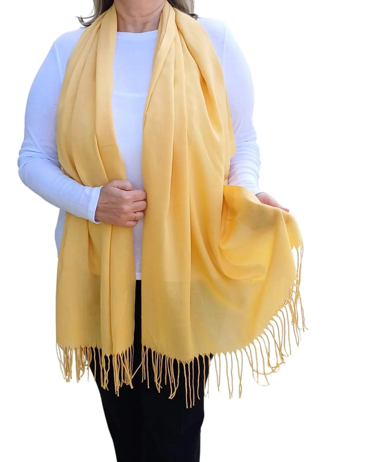 Model wearing custard yellow pashmina shawl – soft lightweight wrap with tassels, UK brand