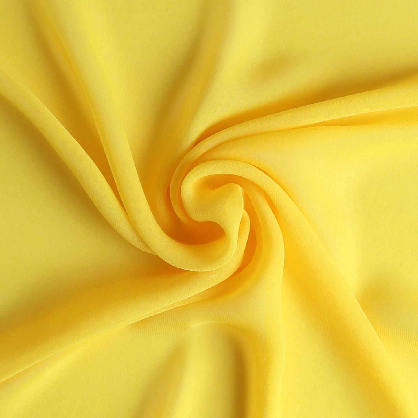 Yellow chiffon scarf close-up in swirl shape – soft lightweight fabric texture, Aurora’s Array all-season fashion accessory UK