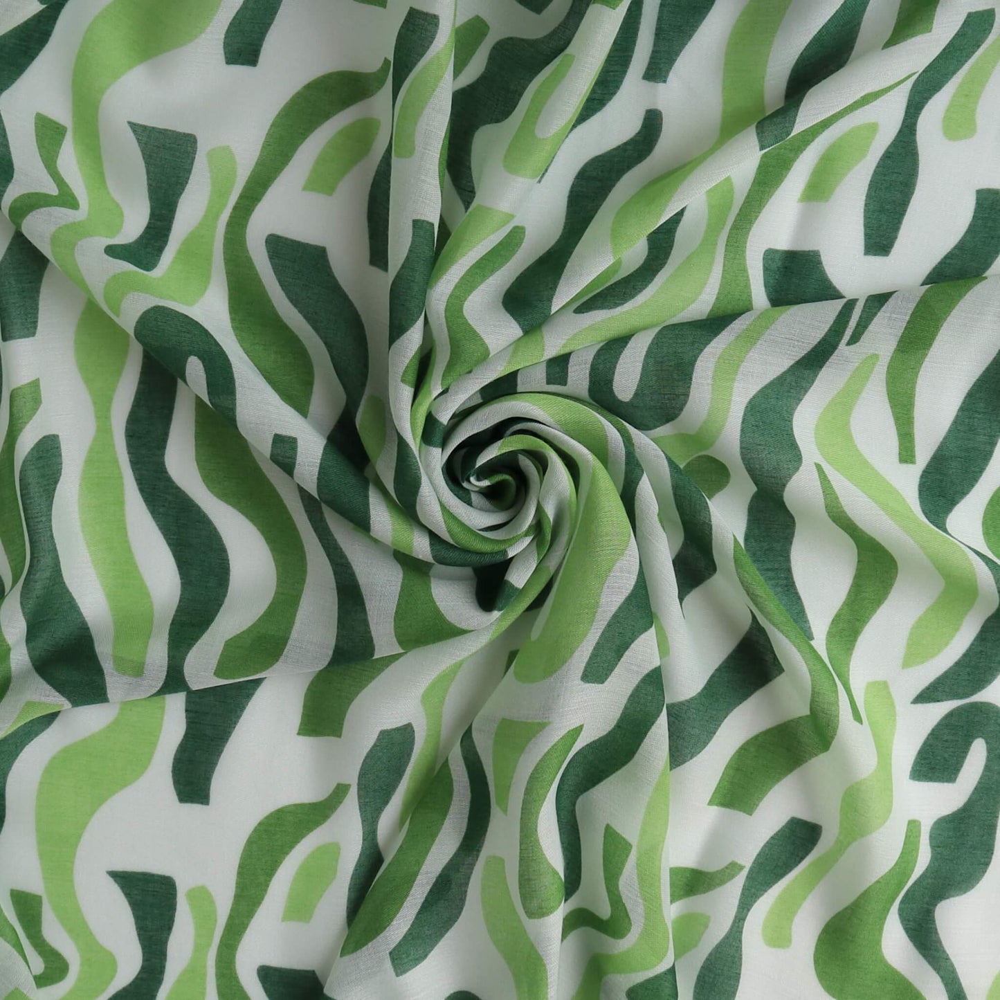 Green and white sarong fabric with an abstract, wavy stripe pattern. Sheer, lightweight textile with gentle, spiraling folds.