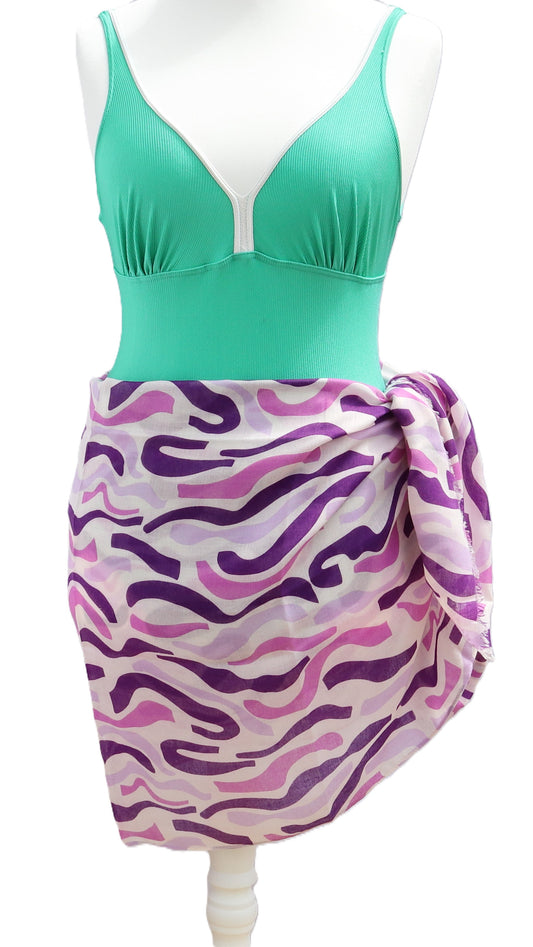 Purple and white patterned sarong tied at the side. Light, airy fabric with abstract, flowing stripes in shades of lilac and deep purple.